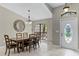 Bright dining room featuring a large window, decorative mirror, modern lighting and tiled flooring at 1007 Golf View Estates Dr, Orange City, FL 32763