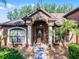 Inviting front entrance with decorative door, columns, and manicured landscaping at 1007 Golf View Estates Dr, Orange City, FL 32763
