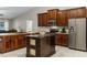 Spacious kitchen with stainless steel appliances, custom cabinets, center island, and tile flooring at 1007 Golf View Estates Dr, Orange City, FL 32763