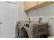 Convenient laundry room with modern appliances and built-in cabinetry at 1007 Golf View Estates Dr, Orange City, FL 32763