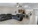 Open-concept living area featuring tile flooring, large sectional sofa, and seamlessly connects to the kitchen at 1007 Golf View Estates Dr, Orange City, FL 32763