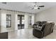 Inviting living room features tile floors, ceiling fan and sliding glass doors to outdoor living space at 1007 Golf View Estates Dr, Orange City, FL 32763