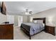 Comfortable primary bedroom with a ceiling fan and well-appointed with an ensuite bathroom at 1007 Golf View Estates Dr, Orange City, FL 32763