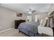 Spacious primary bedroom featuring a television, ceiling fan, and access to the ensuite bathroom and other rooms at 1007 Golf View Estates Dr, Orange City, FL 32763