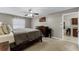Main bedroom with a ceiling fan, a TV, and easy access to the kitchen and bathroom at 1007 Golf View Estates Dr, Orange City, FL 32763
