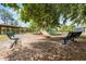 Community playground with benches, swings, slides, and a covered picnic area under a canopy of trees at 1007 Golf View Estates Dr, Orange City, FL 32763