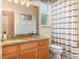 The bathroom features granite countertops, a large mirror, and updated lighting fixtures at 10222 Marsh Pine Cir, Orlando, FL 32832