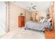 Comfortable bedroom featuring a ceiling fan, carpeted floors, and soothing natural light from the window at 10222 Marsh Pine Cir, Orlando, FL 32832