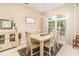 Dining room featuring wood table, accent rug, and large window providing natural light at 10222 Marsh Pine Cir, Orlando, FL 32832