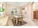 Bright dining room with a rustic table set, large window, and neutral color scheme at 10222 Marsh Pine Cir, Orlando, FL 32832