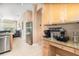 Open concept kitchen with stainless steel appliances and granite countertops and a coffee bar at 10222 Marsh Pine Cir, Orlando, FL 32832
