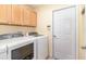 Functional laundry room with cabinets, washer, and dryer hookups at 10222 Marsh Pine Cir, Orlando, FL 32832