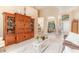 Living room with wood entertainment center and archways leading to dining room and front door at 10222 Marsh Pine Cir, Orlando, FL 32832