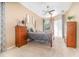 Comfortable main bedroom featuring a ceiling fan, natural light, and neutral color palette at 10222 Marsh Pine Cir, Orlando, FL 32832