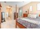 Comfortable main bedroom featuring a four poster bed, natural light, and neutral color palette at 10222 Marsh Pine Cir, Orlando, FL 32832