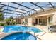 Enjoy outdoor living with a private pool, spa, and screened enclosure with plenty of seating and a grill at 10222 Marsh Pine Cir, Orlando, FL 32832