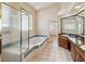 Bathroom featuring a soaking tub, walk-in shower, double vanity, and white tile flooring at 1024 Featherstone Cir, Ocoee, FL 34761