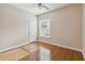 Bedroom with wood floors, a window with blinds, and neutral wall color at 1024 Featherstone Cir, Ocoee, FL 34761