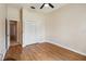 Empty bedroom with warm wood floors and a double door closet at 1024 Featherstone Cir, Ocoee, FL 34761