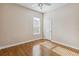Bedroom with warm wood floors, a window for natural light, and neutral paint at 1024 Featherstone Cir, Ocoee, FL 34761