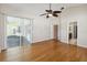 Spacious bedroom with wood floors, ceiling fan, and a sliding glass door to the patio at 1024 Featherstone Cir, Ocoee, FL 34761