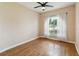 This bedroom has hard wood floors, ceiling fan, and a window with a view of the outdoors at 1024 Featherstone Cir, Ocoee, FL 34761