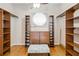 Large walk-in closet with custom built-in shelving and storage space at 1024 Featherstone Cir, Ocoee, FL 34761