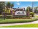 The Hammocks community sign with brick wall, green landscaping, and colorful flowerbed at 1024 Featherstone Cir, Ocoee, FL 34761