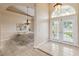 Bright foyer with neutral tile flooring and archway looking into staged dining room with chandelier at 1024 Featherstone Cir, Ocoee, FL 34761