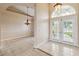Bright foyer with neutral tile flooring, chandelier, arched doorway, and glass paneled front doors at 1024 Featherstone Cir, Ocoee, FL 34761