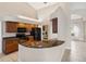 Well-equipped kitchen with granite counters, wood cabinets, and stainless steel appliances at 1024 Featherstone Cir, Ocoee, FL 34761
