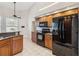 Kitchen with black appliances, granite countertops, wood cabinets, and stainless steel appliances at 1024 Featherstone Cir, Ocoee, FL 34761