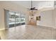 Bright living room with sliding glass doors to the pool area and modern ceiling fans at 1024 Featherstone Cir, Ocoee, FL 34761