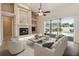 Spacious living room with fireplace, built-in shelves, ceiling fan, tile floors, and virtual staging at 1024 Featherstone Cir, Ocoee, FL 34761