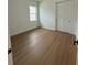 Neutral bedroom features hard wood flooring, closet, and a window offering natural light at 1043 Gloryland Ct, Sanford, FL 32771