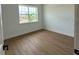 Bright bedroom with hardwood flooring and a large window offering serene views at 1043 Gloryland Ct, Sanford, FL 32771