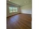 Bright bedroom with hardwood floors, large windows, recessed lights, and a trey ceiling at 1043 Gloryland Ct, Sanford, FL 32771