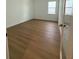 Bright, clean bedroom with wood flooring and a large window to let in natural light at 1043 Gloryland Ct, Sanford, FL 32771