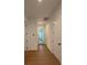Bright hallway with wood flooring and white trim offers a simple, clean design at 1043 Gloryland Ct, Sanford, FL 32771