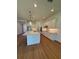 Open kitchen featuring white cabinetry, a large island with sink, and stainless appliances at 1043 Gloryland Ct, Sanford, FL 32771