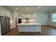 Bright kitchen featuring a large island, stainless appliances, pendant lighting, and white cabinetry at 1043 Gloryland Ct, Sanford, FL 32771