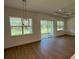 Bright living room with hardwood floors, recessed lights, and a glass sliding door to the backyard at 1043 Gloryland Ct, Sanford, FL 32771