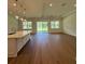 Open floor plan with a spacious living area, modern kitchen island, and sliding doors to outdoor space at 1043 Gloryland Ct, Sanford, FL 32771