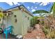 Backyard with lush greenery, stepping stone pathway, patio, and an exterior wall at 108 Orion Way, Sanford, FL 32773
