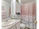Cozy bathroom with shower and tub combination featuring marble design shower curtain and white sink at 108 Orion Way, Sanford, FL 32773