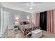 Comfortable bedroom with tile flooring, ceiling fan, and coordinated furniture and decor at 108 Orion Way, Sanford, FL 32773