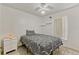 Bedroom featuring ceiling fan and bed with black and white patterned comforter and white nightstand at 108 Orion Way, Sanford, FL 32773