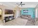 Spacious living room with neutral tile flooring, ceiling fan, and entertainment center with fireplace at 108 Orion Way, Sanford, FL 32773