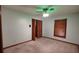 Cozy bedroom with carpeted floor, wood trim, simple closet doors and a ceiling fan with light at 11624 Delmar Ave, Orlando, FL 32836