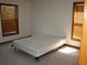 Neutral bedroom with a simple bed frame, wood trim, and blinds that allows plenty of light to flow through at 11624 Delmar Ave, Orlando, FL 32836